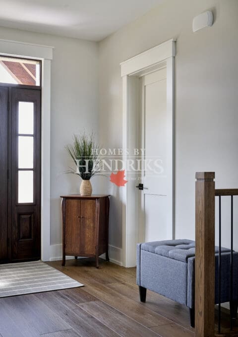 A welcoming entryway featuring a spacious, open design with rustic timber framing and elegant finishes.