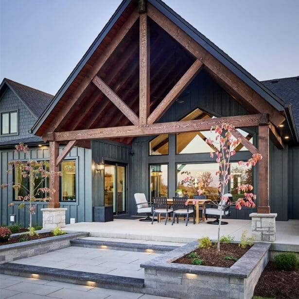 A beautifully designed rear patio featuring interlocking pavers that create a durable, stylish outdoor space.