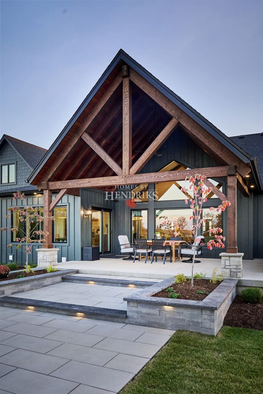 A beautifully designed rear patio featuring interlocking pavers that create a durable, stylish outdoor space.
