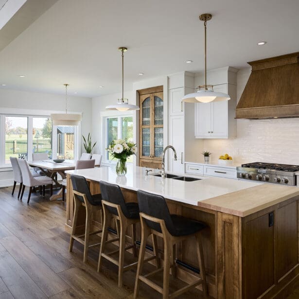 A large, custom kitchen island featuring contrasting wood tones that add visual interest and functionality.