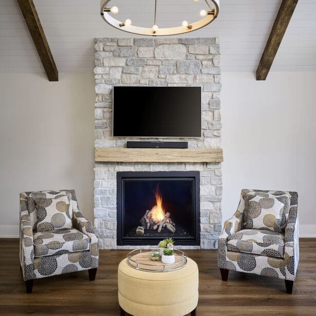 A striking stone fireplace serving as the focal point of the living area, featuring natural stone masonry that adds rustic elegance and earthy charm.